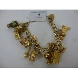 A 9ct gold curb link charm bracelet, featuring a globe,