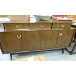 A G-Plan mahogany finished sideboard, the platform top with three in-line drawers,