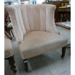 An early 20thC tub style chair with a curved back and overstuffed seat,