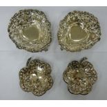 A pair of decoratively pierced silver heart shaped sweet dishes;