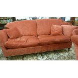 A modern, traditionally styled, three person settee, having a slightly arched, angled back and high,