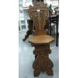 An early 20thC fruiting vine carved, light oak chair,