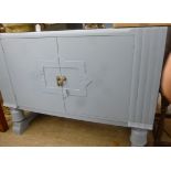 A 1930s, later pale blue painted sideboard with a low upstand and a pair of doors,