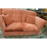 A modern, traditionally styled, two person settee, having a slightly arched, angled back and high,