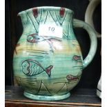 A Mabel Leigh pottery jug of bulbous form, decorated in tones of green,