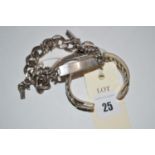 Two heavy silver curb link identity bracelets;