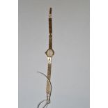 An ladies Accurist 9ct. yellow gold cased cocktail watch, on 9ct. yellow gold baton link strap.