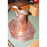 An Arts & Crafts style copper tapering jug with flared rim and loop handle, inscribed on the base,