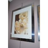 A decorative print of white anemones, in silver coloured frame.