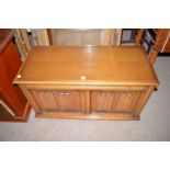 A mid 20th Century stained oak blanket box with linen fold decorated panels to front.