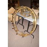 A large and heavy brass circular hanging light fitting,