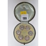 A set of six white metal buttons depicting a courting couple,