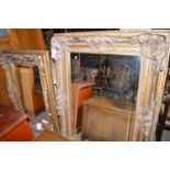 Two rectangular bevelled wall mirrors, in gold coloured frames decorated with shells,