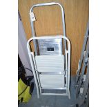 A pair of aluminium step ladders; and a white painted set of two-stepped ladders.