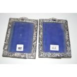 A pair of silver mounted photograph frames decorated with scrolling design, by H.