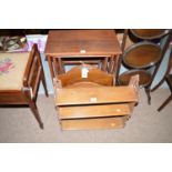 A stained wood magazine rack; together with a nest of three occasional tables in dark stained teak,