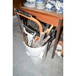 A bucket of assorted saws; etc.