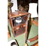 A smoker's oak cabinet with decorative geometric mouldings on the door,