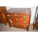 An early 19th Century chest of three long graduated drawers with brass handles,