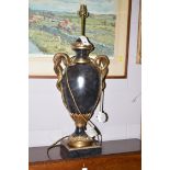 A black urn-shaped table lamp on square base with gilt decoration and intertwined gilt snake