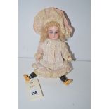 A late Victorian Armand Marseilles doll, wearing pink cotton and cream-lace bonnet and dress,