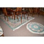 A large Chinese carpet with duck-egg blue ground and floral decoration;