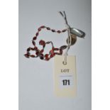 A garnet coloured stone cabouchon necklace in white metal,