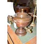 An early 20th Century copper samovar with brass tap and two turned wooden handles.