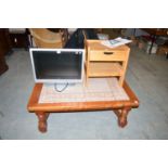 A Bush television; a pine bedside table; and a tiled top coffee table, raised on turned legs.