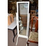 A white painted cheval mirror, the rectangular glass within ribbon decorated frame,