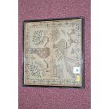 A 19th Century sampler depicting a cat, birds and other animals amongst a house, tree and foliage,