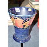 An early 20th Century Moorcroft flared vase in 'Pomegranate' pattern, on blue ground,