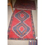 A Beluche rug, stylised geometric double medallion, 86 x 135cms.