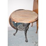 A cast iron base Britannia bar table with turned wooden top,