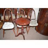 Three dark stained Ercol Windsor type chairs, two single, one open arm,