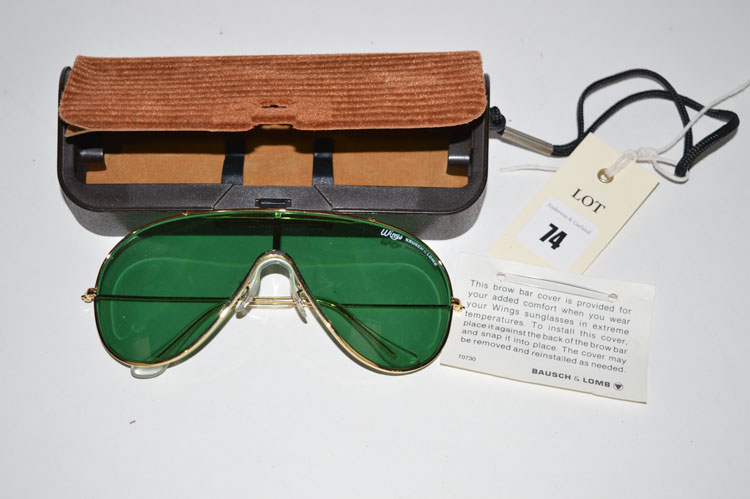 A pair of vintage Bausch & Lomb 'Wings' green tinted sunglasses, with detachable brow bar present,