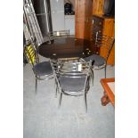 A glass top table with chrome base; together with four chairs.