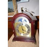 A modern bracket clock, the silvered roman dial within gilt design under moon phase, by Hermle.