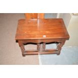 A stained oak nest of three occasional tables,