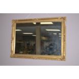 A modern gold painted framed rectangular wall mirror, decorated with shell,