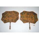 A pair of late 19th Century papier mache face screens, printed with homourous scenes, 24cms wide .