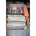 A box of videos; classical CD's; and long playing records.
