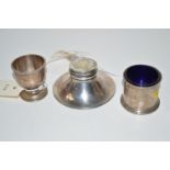 A silver capstan form inkwell; a silver egg cup; and a silver table salt with blue glass liner.