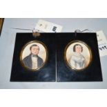 A pair of miniature portraits in ebonised frames,