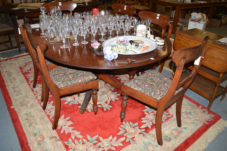 A reproduction Georgian style mahogany oval dining table fitted one leaf,
