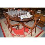 A reproduction Georgian style mahogany oval dining table fitted one leaf,