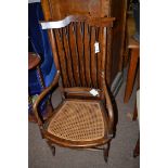 A simulated rosewood armchair, with twisted spindle back and cane seat.