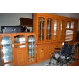 Three matching sitting room units with glazed and solid panelled doors and drawers.