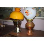 A copper oil lamp with opaque white glass shade and pheasant decoration;
