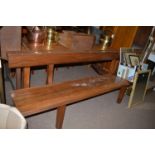 A stained wood bench, the shaped back and seat raised on square legs.